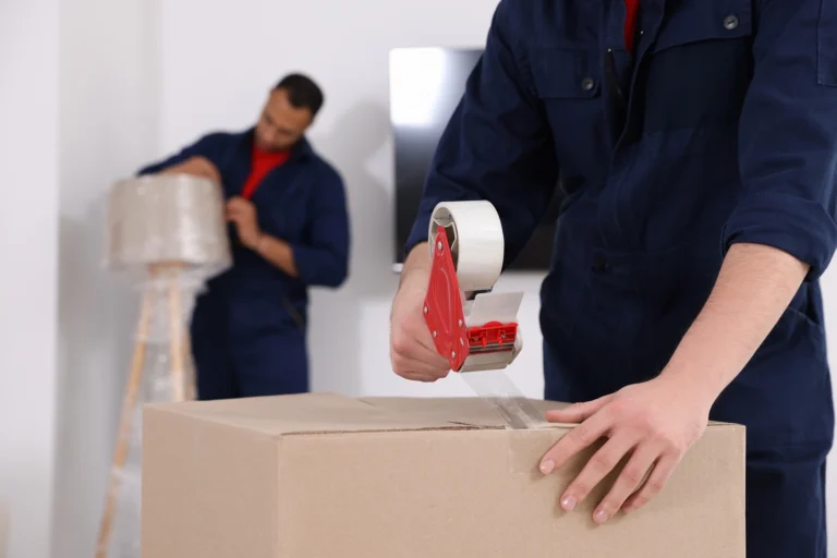 Movers pack up items with bulk moving boxes.